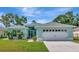 Charming single-story home with a well-manicured lawn, blue exterior paint and a two-car garage at 3718 61St E Dr, Bradenton, FL 34203