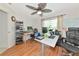 The home office features hardwood floors, a large desk, and a ceiling fan at 3718 61St E Dr, Bradenton, FL 34203