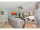 Open-concept living room with tile floors, modern decor, a ceiling fan, and sliding glass doors to the pool area at 3718 61St E Dr, Bradenton, FL 34203