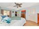 The main bedroom has wood floors, a ceiling fan, and soft blue walls, plus sliding glass doors at 3718 61St E Dr, Bradenton, FL 34203