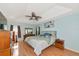 The main bedroom boasts wood floors, a ceiling fan, and soft blue walls at 3718 61St E Dr, Bradenton, FL 34203