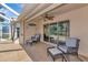 Cozy outdoor patio with comfortable seating, fan, and serene backyard views at 3718 61St E Dr, Bradenton, FL 34203