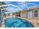 Large backyard pool with screened lanai offering views of the surrounding landscape at 3718 61St E Dr, Bradenton, FL 34203