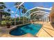 Serene pool area with inviting blue water, mature palms, and a screened enclosure at 3718 61St E Dr, Bradenton, FL 34203
