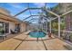Inviting screened-in pool area with ample seating and lush tropical landscaping at 3718 61St E Dr, Bradenton, FL 34203