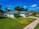 Well-manicured lawn and landscaping surround this single-story home at 3718 61St E Dr, Bradenton, FL 34203