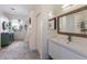 Bright bathroom featuring a modern vanity, decorative mirror, and stylish accents enhancing the room's appeal at 3806 72Nd E Ter, Sarasota, FL 34243