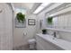 Bright bathroom featuring a white vanity, toilet, framed art, and modern decor at 3806 72Nd E Ter, Sarasota, FL 34243