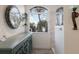 Bathroom detail showcasing a decorative mirror, hanging plants, and marble-tiled shower for a spa-like feel at 3806 72Nd E Ter, Sarasota, FL 34243
