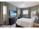Comfortable bedroom featuring natural light, a tv, dresser and a treadmill at 3806 72Nd E Ter, Sarasota, FL 34243