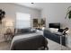 Comfortable bedroom with a well-lit desk area, perfect for work or study, complemented by stylish decor at 3806 72Nd E Ter, Sarasota, FL 34243