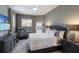 Comfortable bedroom with a treadmill, black furnishings, and a view to the outside at 3806 72Nd E Ter, Sarasota, FL 34243
