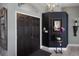 Cozy entryway with a dark wood double door, ambient chandelier, and a mirror with orchids at 3806 72Nd E Ter, Sarasota, FL 34243