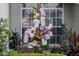 Close up of colorful orchid arrangement with window in background and green leafy plants at 3806 72Nd E Ter, Sarasota, FL 34243