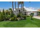 Single-story home features a white tiled roof and meticulously maintained lawn with decorative landscaping at 3806 72Nd E Ter, Sarasota, FL 34243