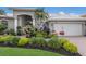 Well-manicured landscaping surrounds this home with a brick driveway and an attached two-car garage at 3806 72Nd E Ter, Sarasota, FL 34243