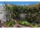 Close up of colorful garden with cactus and flowering bushes against a bright wall at 3806 72Nd E Ter, Sarasota, FL 34243