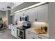 Modern kitchen with stainless steel microwave and range, white cabinets, and quartz countertops at 3806 72Nd E Ter, Sarasota, FL 34243