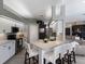Modern kitchen with white cabinets, stainless steel appliances, quartz countertops, and island with seating at 3806 72Nd E Ter, Sarasota, FL 34243