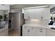 Contemporary kitchen with stainless steel refrigerator, white cabinets, and sleek countertops at 3806 72Nd E Ter, Sarasota, FL 34243