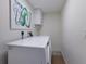 Bright laundry room with a side-by-side washer and dryer and modern decor at 3806 72Nd E Ter, Sarasota, FL 34243