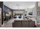 Beautifully staged living room boasts sliding doors with a view of the outdoor pool and a plush leather sofa at 3806 72Nd E Ter, Sarasota, FL 34243
