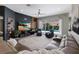 Beautifully staged living room boasts sliding doors with a view of the outdoor pool and a plush leather sofa at 3806 72Nd E Ter, Sarasota, FL 34243