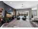 Spacious living room with sliding glass doors to pool, leather sofa, modern decor, and ceiling fan at 3806 72Nd E Ter, Sarasota, FL 34243