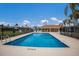 Sparkling community pool with inviting lounge area and secure fencing at 3806 72Nd E Ter, Sarasota, FL 34243