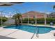 Beautiful backyard pool area featuring tropical landscaping, blue skies, and screened enclosure at 3806 72Nd E Ter, Sarasota, FL 34243