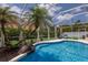 Backyard swimming pool surrounded by tropical landscaping and screened enclosure for ultimate privacy at 3806 72Nd E Ter, Sarasota, FL 34243