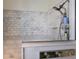 Elegant shower featuring marble tiling, modern fixtures, and a convenient storage niche for toiletries at 3806 72Nd E Ter, Sarasota, FL 34243
