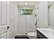 Updated bathroom featuring white subway tile in the shower with a pebble floor and modern fixtures at 3919 Fan Palm Ct, Land O Lakes, FL 34638