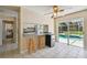 Breakfast nook with stools, refrigerator, and sliding glass doors to the pool at 3919 Fan Palm Ct, Land O Lakes, FL 34638