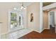 Welcoming foyer featuring tile flooring, a charming niche, and light-filled double front doors at 3919 Fan Palm Ct, Land O Lakes, FL 34638