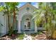 Inviting front entrance with white pillars and double doors with a lovely arched transom window above at 3919 Fan Palm Ct, Land O Lakes, FL 34638