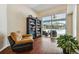 Cozy living room featuring a sliding glass door to the screened-in pool area and wood-look floors at 3919 Fan Palm Ct, Land O Lakes, FL 34638