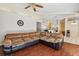 Comfortable living room showcasing a large sectional sofa and views of the adjacent kitchen area at 3919 Fan Palm Ct, Land O Lakes, FL 34638