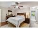 Main bedroom featuring a ceiling fan, laminate flooring, queen sized bed and dressers at 3919 Fan Palm Ct, Land O Lakes, FL 34638