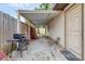 Outdoor patio area featuring a grill, covered seating, and convenient access to an adjacent storage shed at 4023 Chestnut Ave, Sarasota, FL 34234