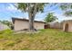 A view of the home's backyard featuring mature trees, partial fencing, and lush greenery at 4023 Chestnut Ave, Sarasota, FL 34234