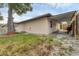 A view of the home's backyard with partial fencing, a utility box, and a covered patio area at 4023 Chestnut Ave, Sarasota, FL 34234