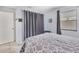 Spacious bedroom featuring a large bed, neutral decor and window with curtains at 4023 Chestnut Ave, Sarasota, FL 34234