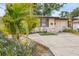 Charming single-story home featuring lush landscaping and a cozy outdoor seating area, perfect for enjoying the Florida sunshine at 4023 Chestnut Ave, Sarasota, FL 34234