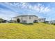 Back of house, with siding, a utility shed and manicured lawn in a community setting at 4119 13Th E St, Ellenton, FL 34222