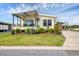 Charming home featuring a covered porch and a well-manicured lawn with lush landscaping at 4119 13Th E St, Ellenton, FL 34222