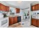 This kitchen features wooden cabinetry and white appliances, near a bright white entry door at 4119 13Th E St, Ellenton, FL 34222