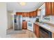 Well-lit kitchen featuring a stainless steel refrigerator and wood cabinets with light countertops at 4119 13Th E St, Ellenton, FL 34222