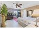 Inviting bedroom includes ceiling fan, dresser, and decorative wallpaper for added charm at 4119 13Th E St, Ellenton, FL 34222