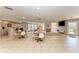 Large recreational space with tables, chairs, a bar, and cozy seating area with a television at 4381 Sandner Dr, Sarasota, FL 34243